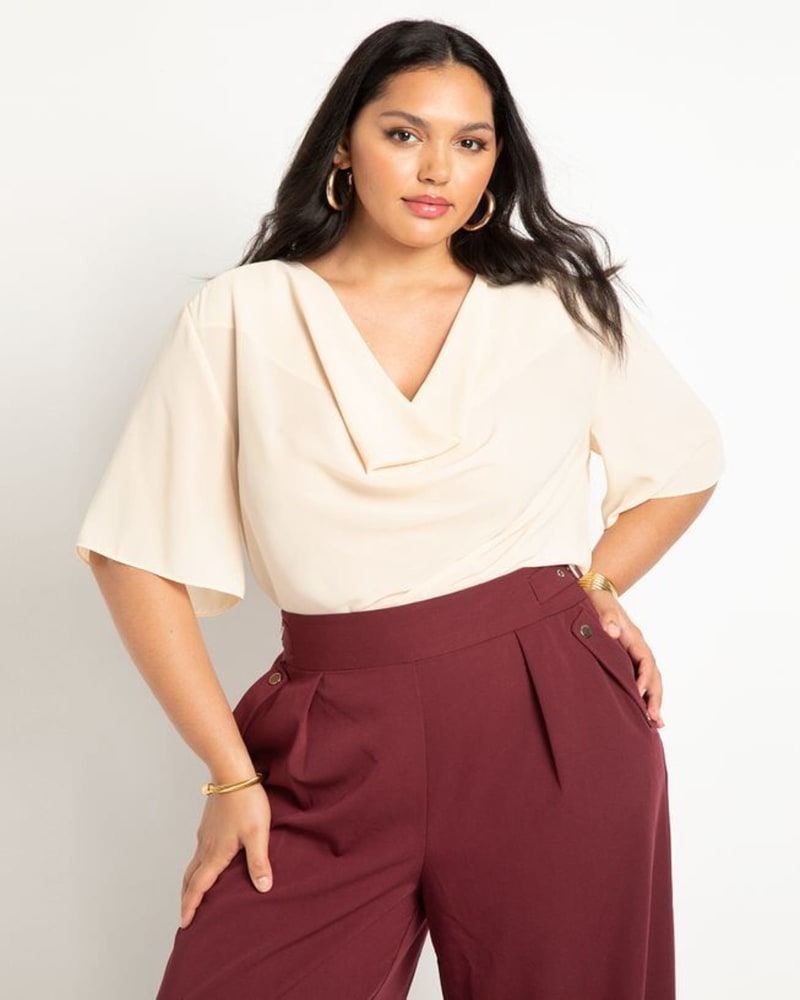Front of a model wearing a size 26 Draped Cowl Top in Cream by ELOQUII. | dia_product_style_image_id:274966